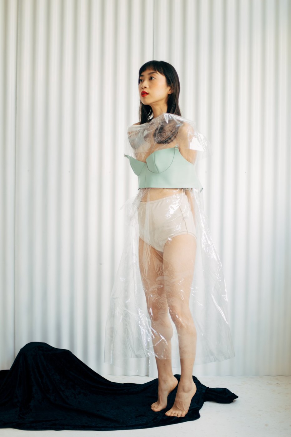 Model in a clear plastic layer and mint bustier